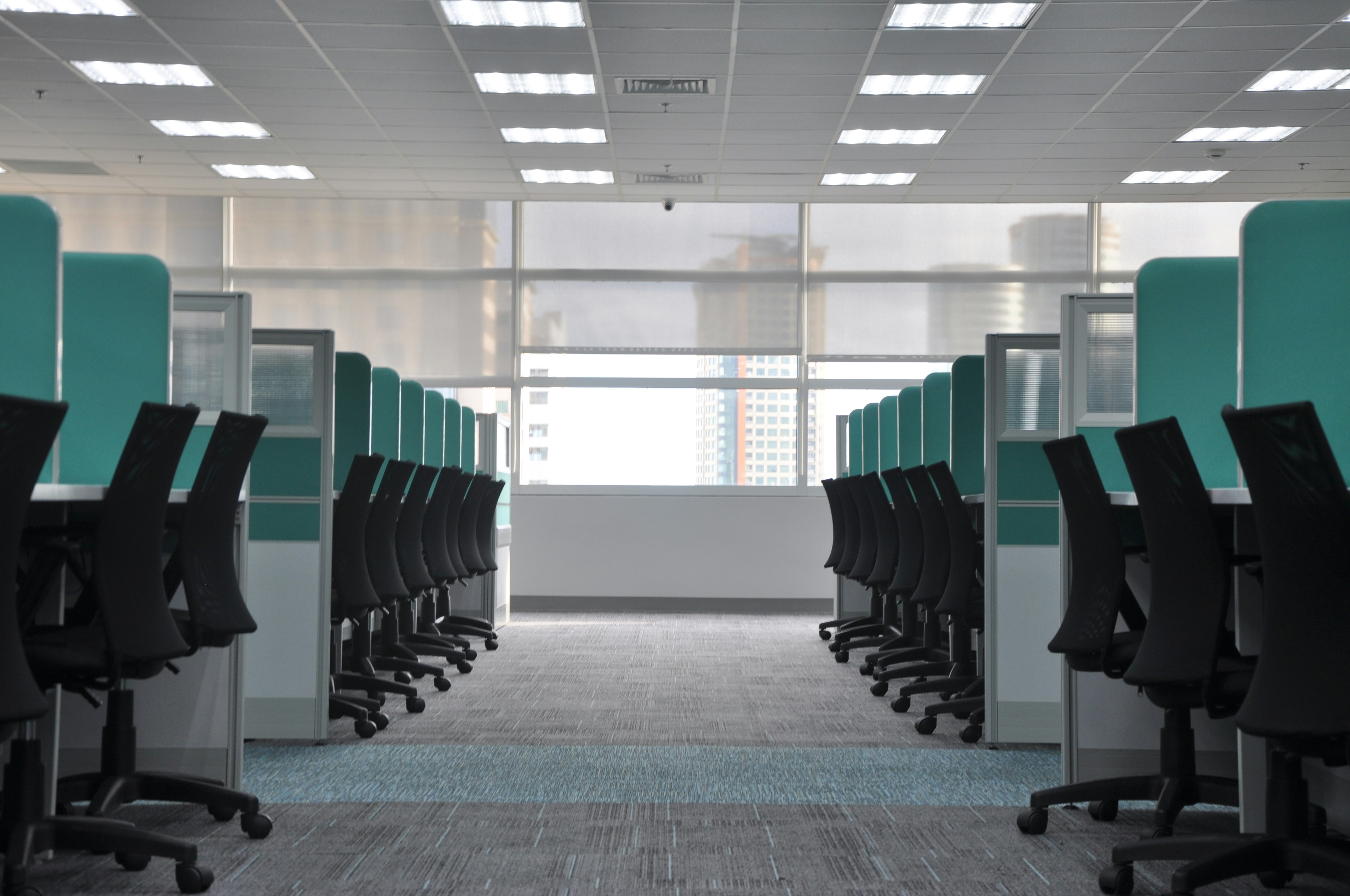 empty black rolling chair at cubicles